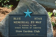 Plaque embedded in large rock  - Shows a large blue star and says Blue Star Memorial Byway - and that plaque presented by Stow Garden Club