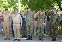 Members of uniformed military personnel saluting