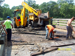 Back-hoe and Highway personnel working on bridge