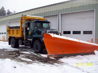 Dump truck with snowplow attachment on front