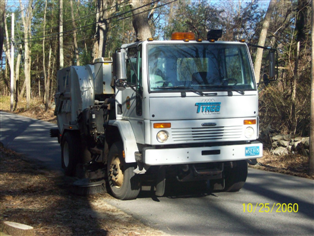 Street Sweeper on road lined with trees