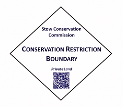 Diamond-shaped sign saying &quot;Conservation Restriction Boundary&quot;